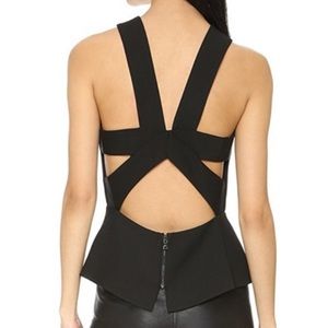 BCBG black peplum top. Size S. Cutout back & high neck.